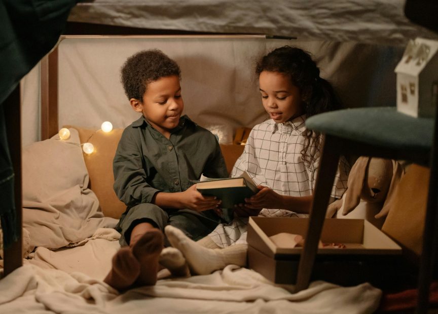 two children playing in their diy den at home.